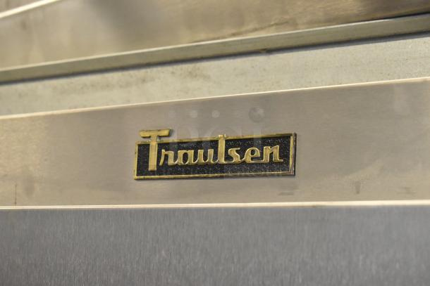 2016 Traulsen G31310 stainless steel 3-door reach-in freezer, poly-coated racks, visible logo, 115/208-230V, 1 phase.
