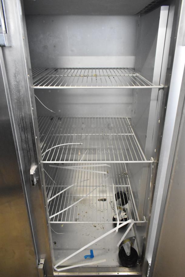 2016 Traulsen G31310 stainless steel commercial 3-door freezer, poly coated racks, 115/208-230V, 1 phase, visible wear.