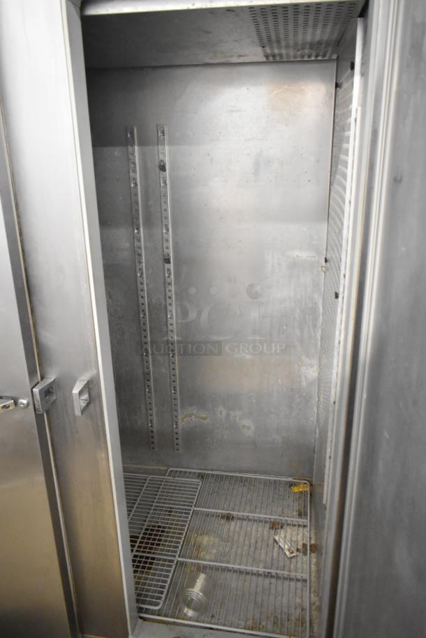 Continental DL2R-SA stainless steel commercial 2-door reach-in cooler, interior view, showing wire shelves and wear.