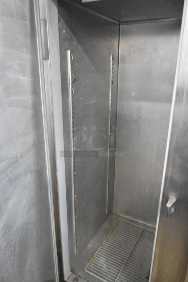 Continental DL2R-SA stainless steel commercial 2-door reach-in cooler interior; visible shelving tracks; used condition.