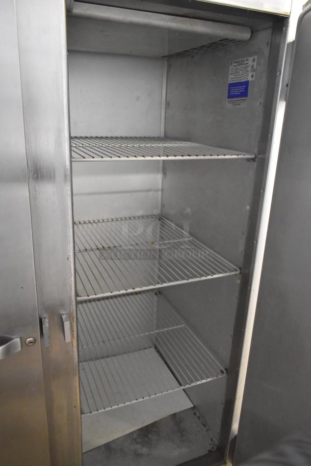 Traulsen G20010 stainless steel 2-door commercial cooler with poly-coated racks, 115 volts, 1 phase; interior view.
