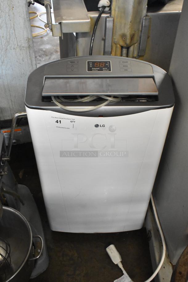 LG LP1415WXRSM Portable Air Conditioner, 14,000 BTU, 115 Volts, digital display, good condition, visible LG logo.