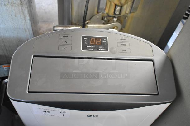 LG LP1415WXRSM Portable Air Conditioner, 14,000 BTU. Control panel with digital display and mode buttons. Used condition.