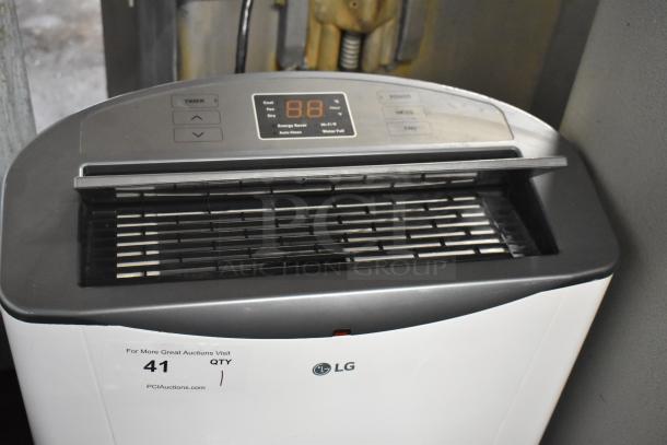LG LP1415WXRSM Portable Air Conditioner, 14,000 BTU, 115V, control panel visible, LG logo, auction tag shown.