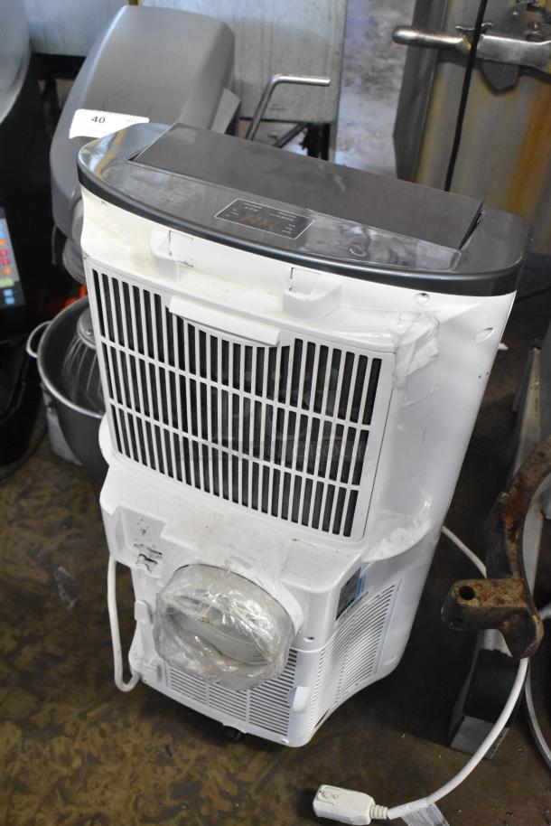 LG LP1415WXRSM Portable Air Conditioner, 14,000 BTU, 115V, used condition with visible wear, plastic wrap on exhaust.