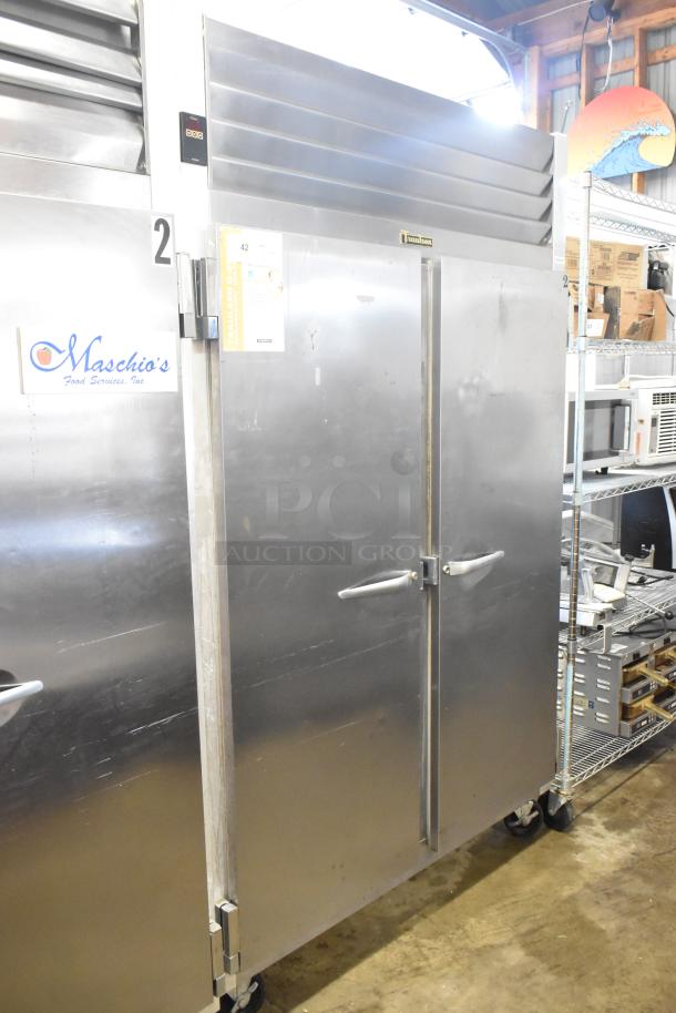 Traulsen G22010 stainless steel commercial 2-door reach-in freezer with poly-coated racks. 115V, 1 phase, in good condition.