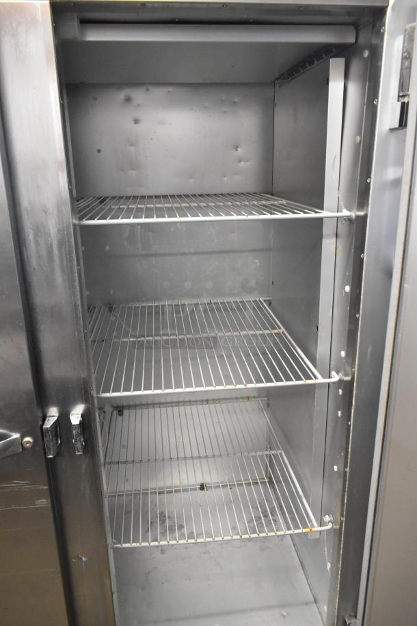 Traulsen G22010 stainless steel commercial 2-door reach-in freezer with poly-coated racks, 115V, 1 phase, good condition.