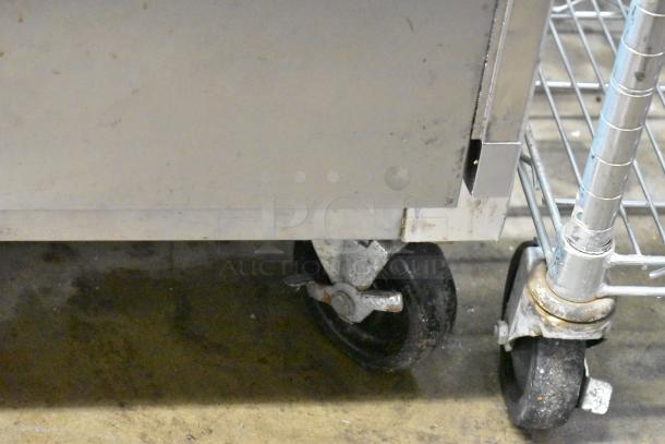 Traulsen G22010 stainless steel commercial 2-door reach-in freezer; visible caster wheels, poly-coated racks, 115V, 1 phase.