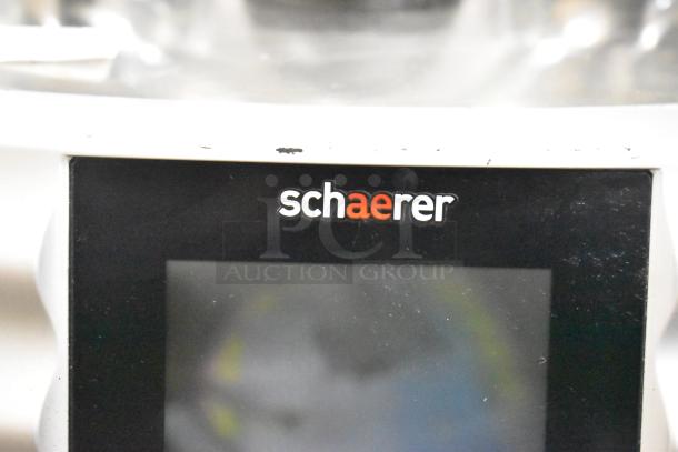 Schaerer Coffee Art Plus espresso machine, commercial countertop model, includes hoppers, shows minimal wear, logo visible.