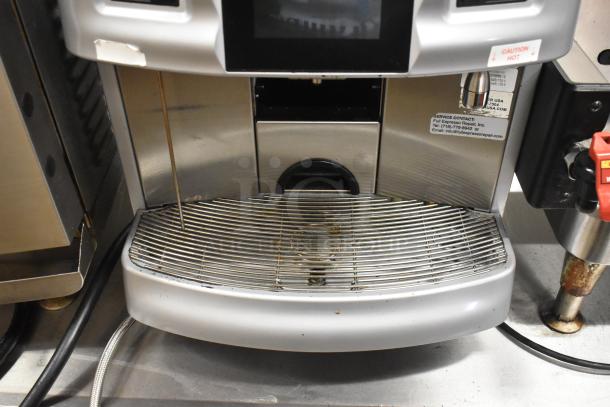 Schaerer Coffee Art Plus automatic espresso machine with hoppers, metal exterior, countertop model, used condition.