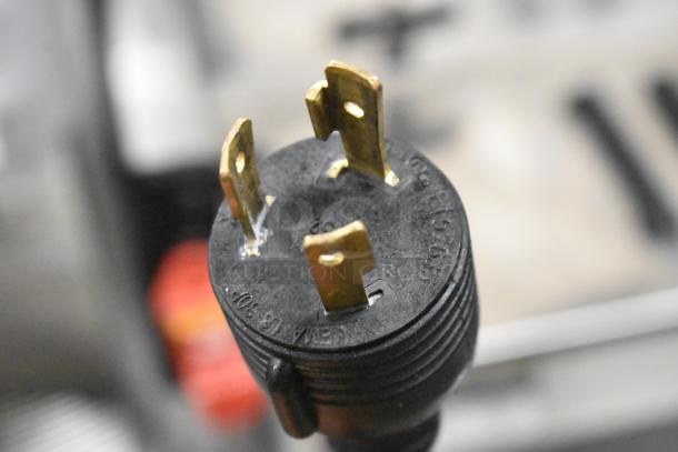 Close-up of a 3-prong plug for the Schaerer Coffee Art Plus commercial espresso machine.