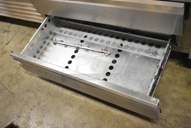 Arctic Air ARCB60CZ stainless steel chef base with two drawers and commercial casters, showing open drawer with perforated design.
