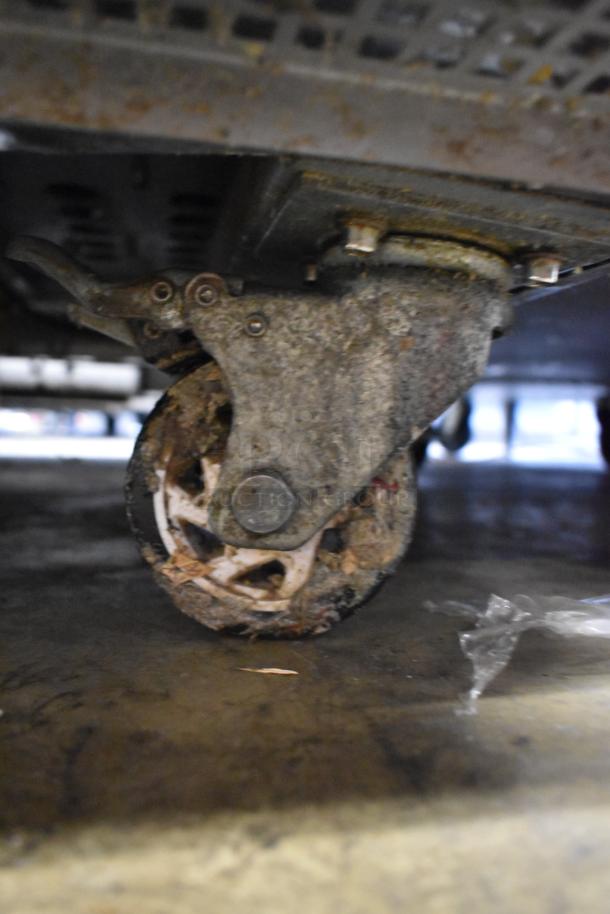 Arctic Air ARCB60CZ stainless steel chef base, showing close-up of used commercial caster wheel, 115 volts, 1 phase.