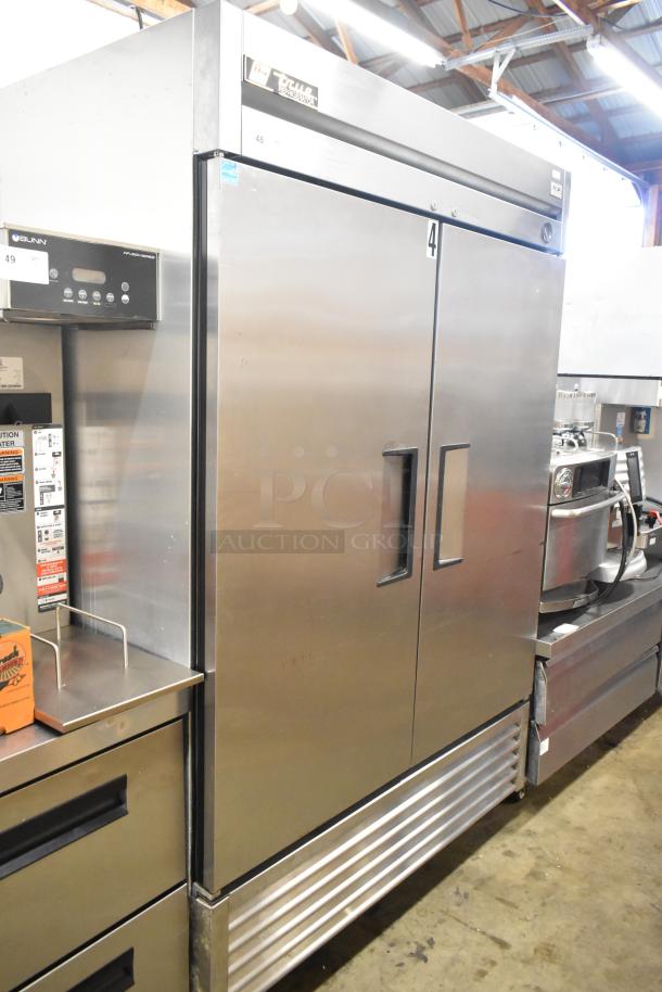 True T-49 stainless steel commercial 2-door cooler with poly-coated racks, on commercial casters. 115V, 1 phase.