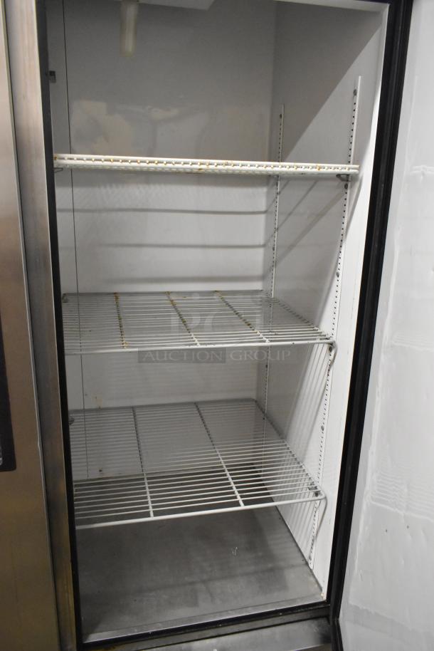True T-49 stainless steel commercial 2-door reach-in cooler with poly-coated racks, on commercial casters, 115 volts, 1 phase.