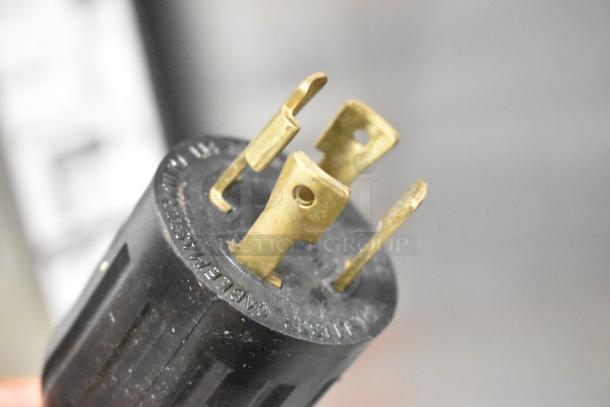 Close-up of plug for 2020 Bunn IC3-DBC Iced Tea Machine, showing heavy-duty brass prongs and black casing.