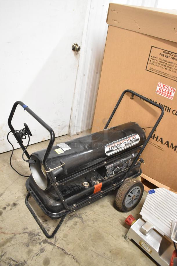 Thermoheat RMC-KFA125TL1 kerosene heater, black, dual heat technology, wheeled base, visible labels, used condition.