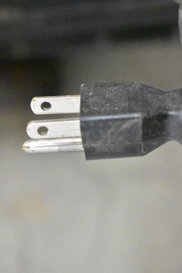 Close-up of a two-pronged power plug for a Thermoheat RMC-KFA125TL1 kerosene heater, showing wear.