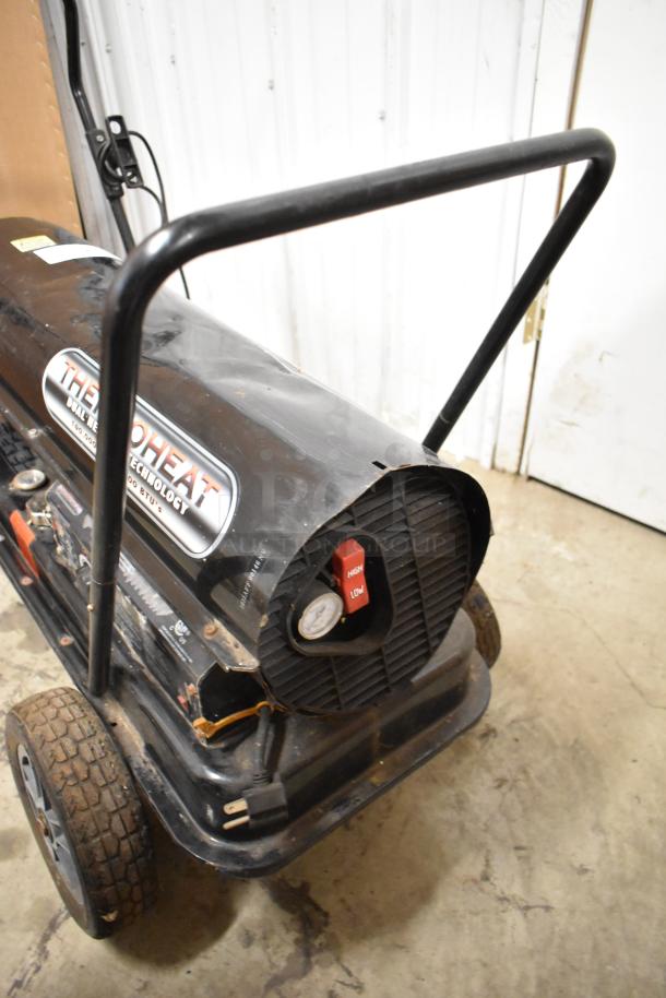 Thermoheat RMC-KFA125TL1 kerosene heater, black, used condition, dual heat technology, visible control panel, and wheels.
