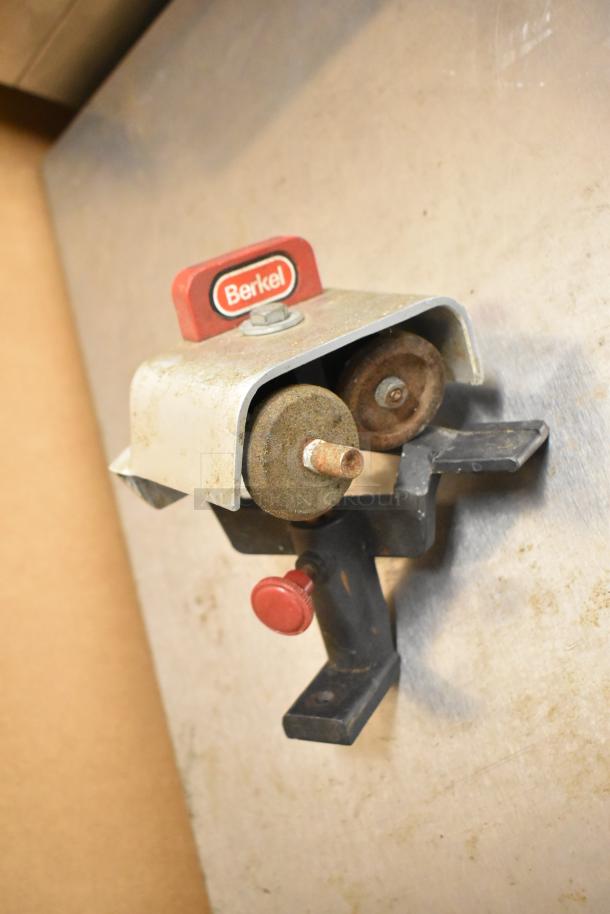 Berkel 827A metal commercial meat slicer with blade sharpener, 115V, 1 phase, features visible branded cover.