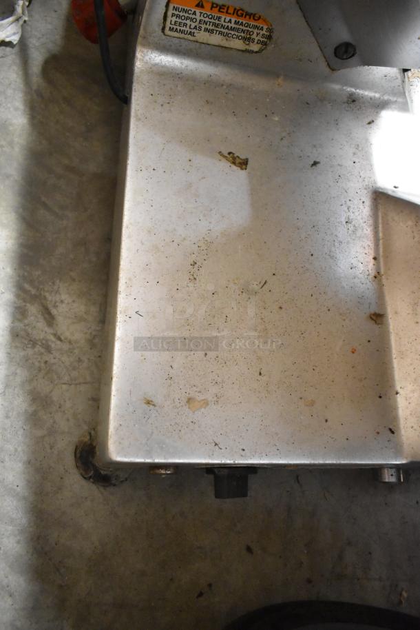 Berkel 827A metal meat slicer with blade sharpener, showing some surface wear. 115 Volts, 1 Phase. Warning label visible.