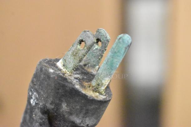 Close-up image of a corroded electrical plug of Berkel 827A meat slicer, indicating wear and potential repair need.