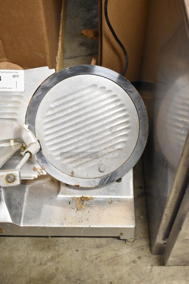 Berkel 827A metal commercial meat slicer with blade sharpener, 115V, 1 phase; shows wear and residue on base.