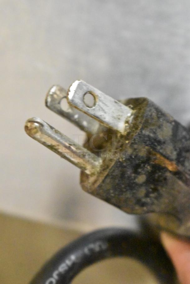 Close-up of a worn power plug attached to a Bunn ITCB-DV iced tea machine. Plug shows signs of corrosion.
