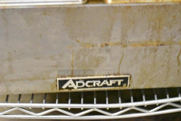 Adcraft stainless steel commercial double fryer with two metal baskets, electric 120V, 1 phase. Used condition, visible wear.