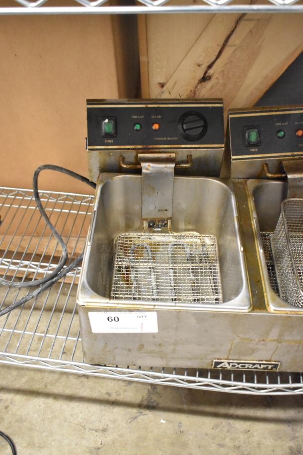 Adcraft stainless steel double fryer with two metal baskets, 120V, 1 Phase, used condition. Power and heat controls visible.