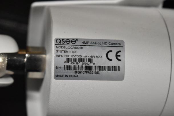 Qsee QCA8075B Security Camera, 4MP Analog HD, model QCA8075B, NTSC system, input DC12V/500mA, made in China.