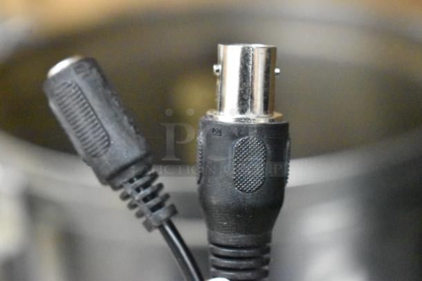 Qsee QCA8075B security camera connectors, showing detail of black cable ends. Model: QCA8075B.