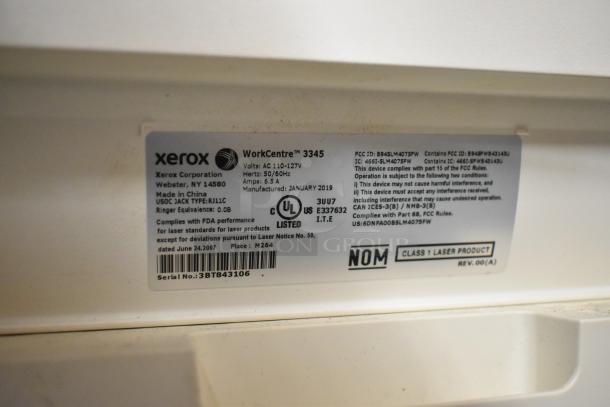 Alt text: Label on Xerox WorkCentre 3345 with specifications and compliance information. Serial number visible.