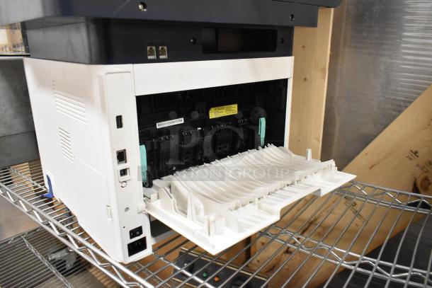 Xerox WorkCentre 3345 printer copier machine on shelf; open front tray, visible ports, appears in good condition.