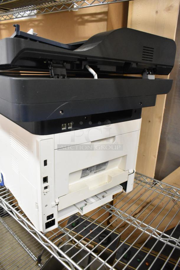 Xerox WorkCentre 3345 countertop printer copier machine, white, visible ports, in good condition on metal shelving.