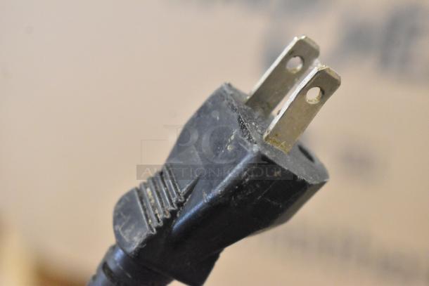Close-up of a two-prong power plug for the Update IC-1800W Stainless Steel Induction Range.