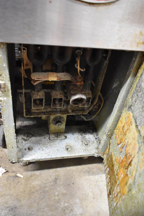 Avantco stainless steel commercial gas fryer with two metal baskets, used condition, visible signs of wear and rust.