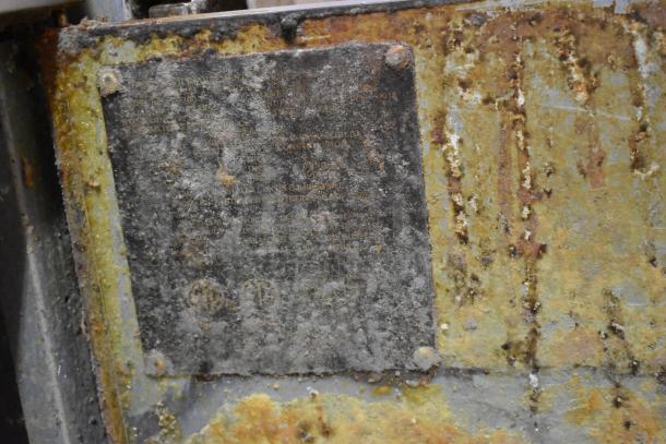 Avantco stainless steel commercial gas fryer with two metal fry baskets, visible rust and wear on exterior, unclear label.