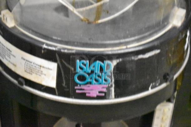 Island Oasis metal countertop frozen drink blending machine, shows wear, logo visible, suitable for commercial use.