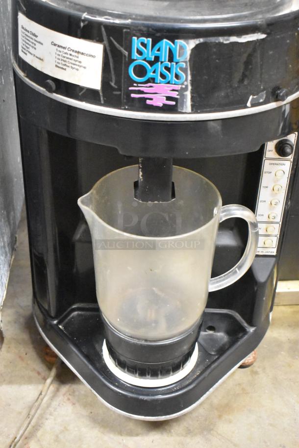Island Oasis metal countertop frozen drink blending machine, black finish, with control panel and pitcher. Used condition.