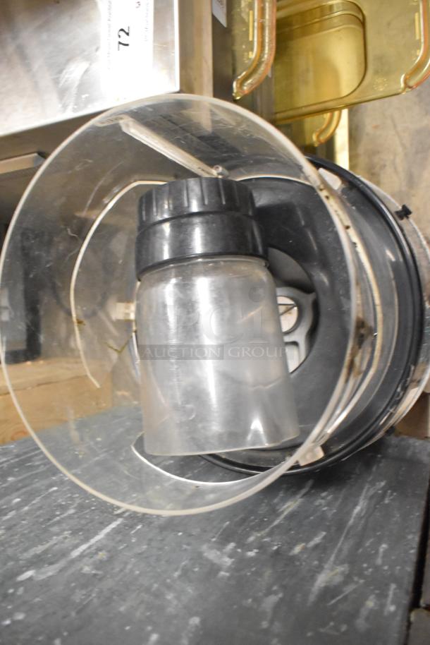 Island Oasis metal countertop frozen drink blending machine, includes clear blending jar and lid. Condition appears used.