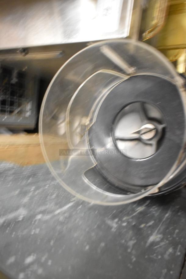 Island Oasis metal countertop frozen drink blending machine, clear plastic container, visible metal components, used condition.