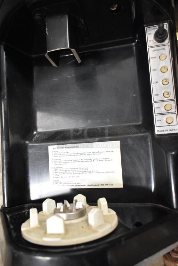 Island Oasis metal countertop frozen drink blending machine, features operation buttons and troubleshooting guide, made in Japan.