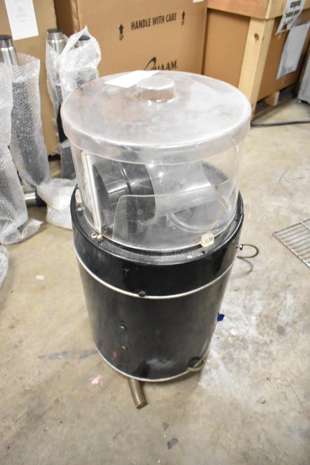 Island Oasis metal countertop frozen drink blending machine, black and silver, used condition, clear lid visible.