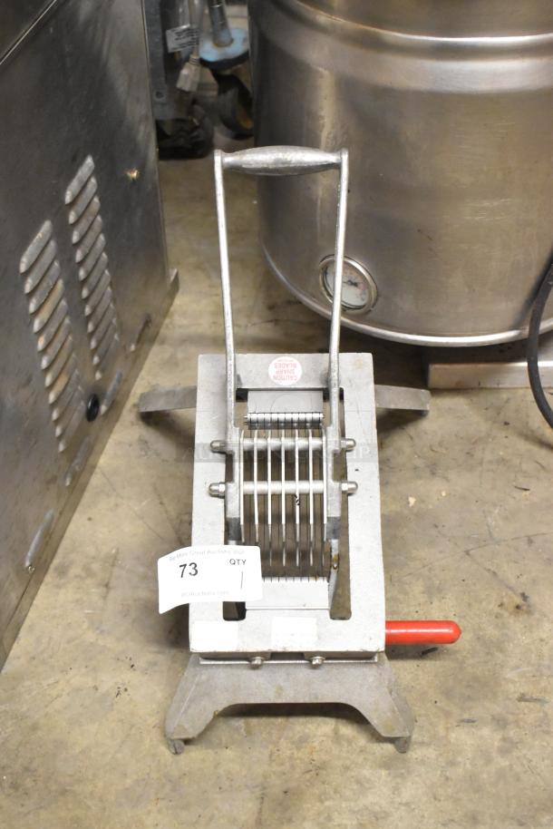 Vollrath Metal Countertop Onion King Slicer, features multiple blades, in used condition. Labels caution sharp blades.