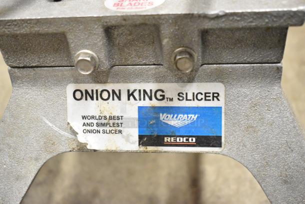 Vollrath Metal Countertop Onion King Slicer, labeled "World's Best and Simplest Onion Slicer," shows brand markings.