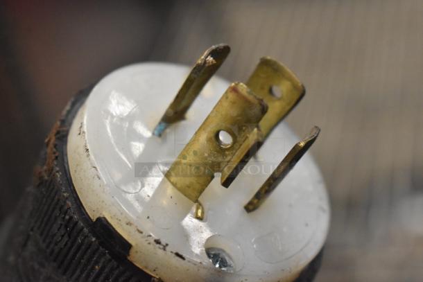 Close-up of electrical plug from the Crown EC-10TM 10 Gallon Steam Kettle, showing metal prongs and wear.