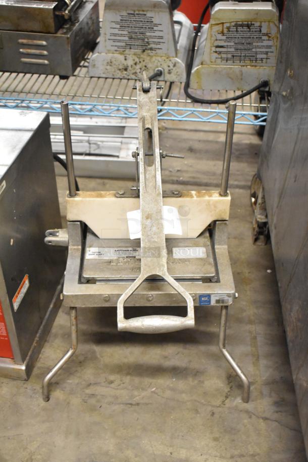 Metal countertop lettuce head cutter in used condition, with stainless steel blades and a sturdy base. NSF certified.