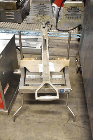Metal countertop lettuce head cutter in used condition, with stainless steel blades and a sturdy base. NSF certified.