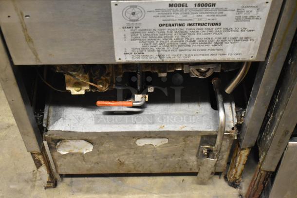 Broaster 1800GH stainless steel gas pressure fryer in used condition, with visible operating instructions label, 65,000 BTU.